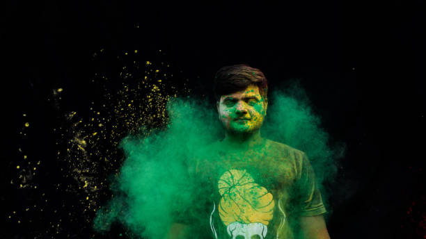 istock man celebrating holi with colors 1208951229