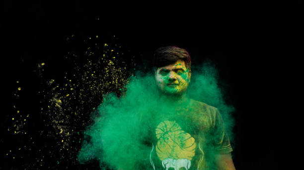 istock man celebrating holi with colors 1208951233