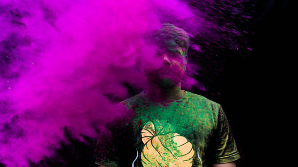 istock man celebrating holi with colors 1208952344