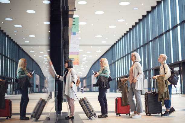 istock Women In Queue At Check-In Counter 1208953336