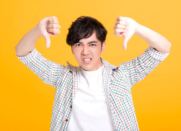 istock young man showing  thumbs down 1208954638