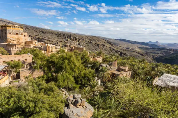 Photo of Misfat al Abriyyin in the Hajar Mountains, Oman. - Date palm tree oasis and water spring at Misfah al Abriyeen village. Sultanate of Oman