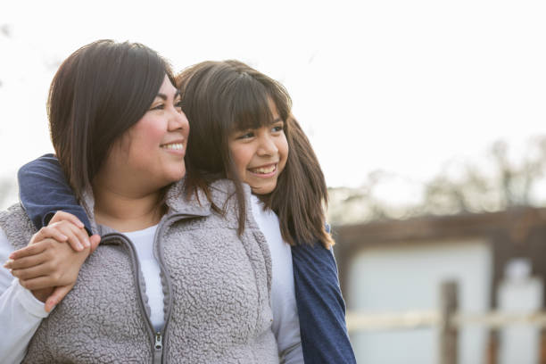 istock Mother and elementary age daughter smile spending quality time together 1208957198