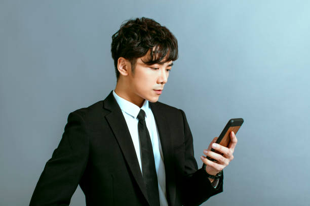 istock Handsome young businessman using mobile phone 1208958181