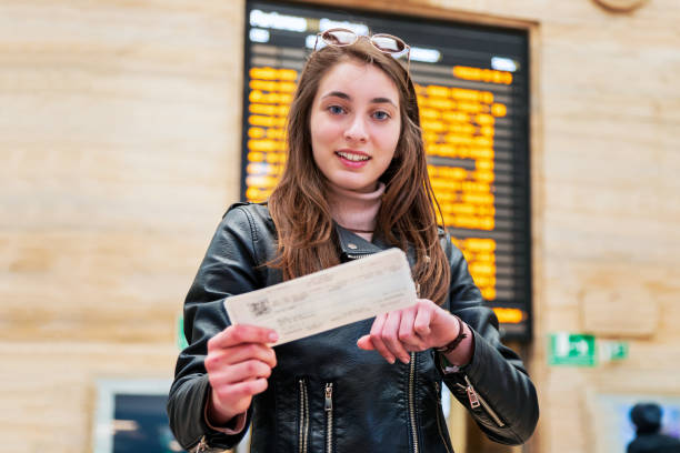 istock Beautiful woman at a train station 1208958337