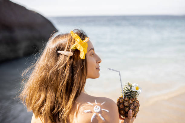 Summer girl with exotic cocktail at the beach resort