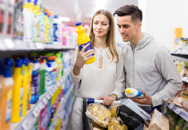 istock Smiling couple choosing household detergents 1208960854