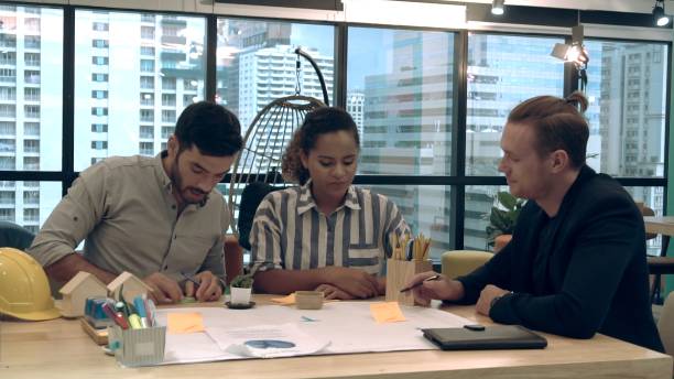 istock Creative business people group having conversation at office desk in workplace. 1208962121
