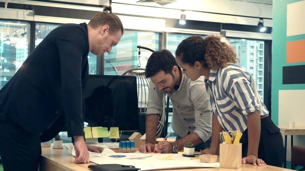 istock Creative business people group having conversation at office desk in workplace. 1208962146