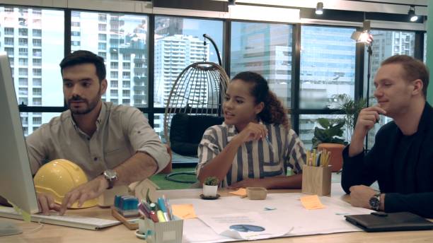 istock Creative business people group having conversation at office desk in workplace. 1208962151