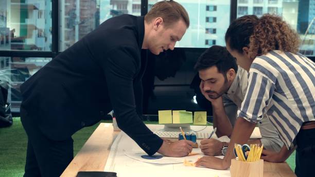 istock Creative business people group having conversation at office desk in workplace. 1208962164