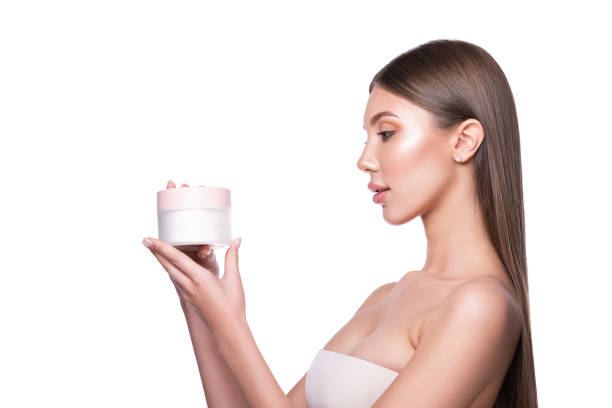 A beautiful woman presents an advertisement product. Model girl with long hair pointing to the side.