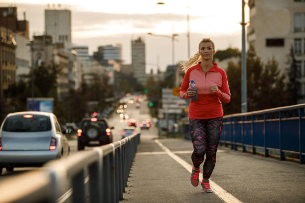 istock Woman running as a part of her exercise routine 1208963707