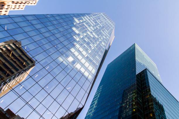 istock Glass wall of office buildings with reflections, bottom view 1208963878