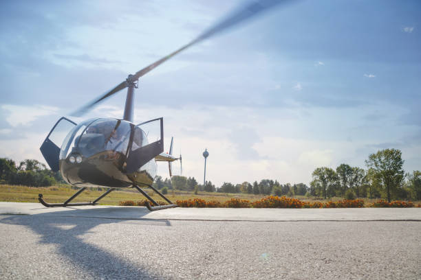 istock Pilots sitting in helicopter with door open and engine on 1208965580