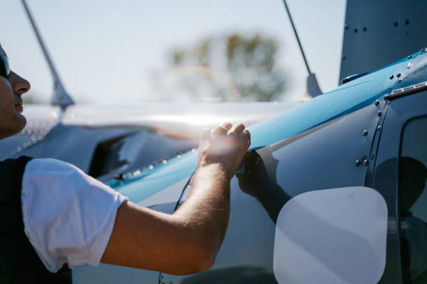 istock Man polishing helicopter exterior with cloth 1208965611