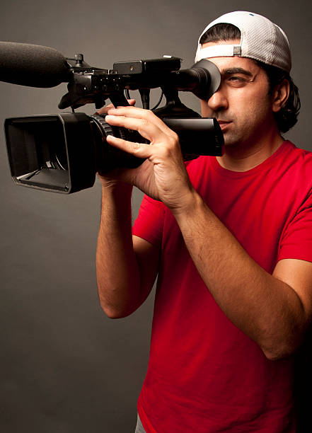 istock Cameraman Shooting Video Against Grey Background 120896670
