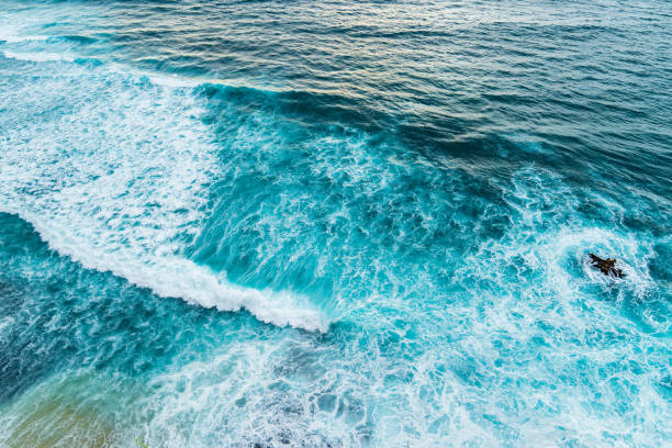 istock Big ocean waves hitting a coral rif. View from above. 1208968670