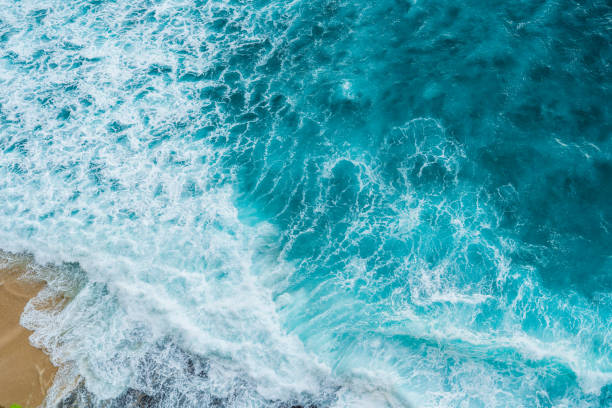 istock Big ocean waves hitting a coral rif. View from above. 1208968674