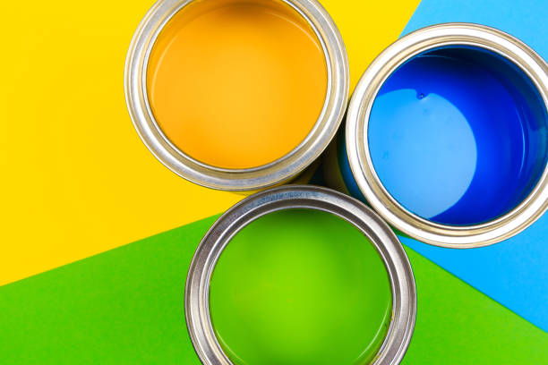 istock Metal paint cans and paint brushes on multicolor background. Top view. Copy space. 1208969778