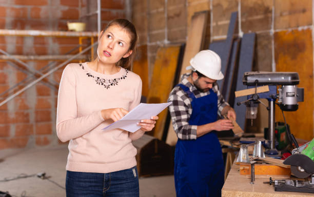 istock Architect with drawing checks the work of builders 1208971964