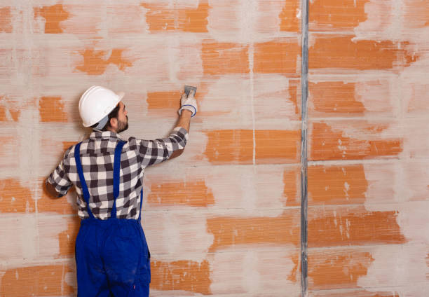 istock Workman is plastering the wall at the place 1208972010