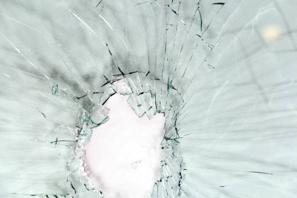 istock Broken glass, a background of cracked glass on a light background. 1208973131