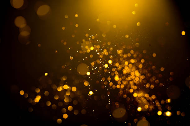 istock Golden abstract bokeh on black background. 1208973255