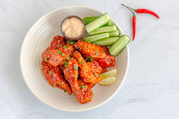 Baked Spicy Chicken Wings Horizontal Top View Photo Baked Spicy Chicken Wings Served with Scallion, Sesame Seeds, Mayonnaise Dip, Directly Above Horizontal Stock Photo on White Background dipping photos stock pictures, royalty-free photos & images