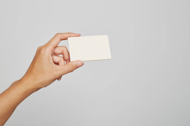 istock Female or Male Hand Holding Blank Card On White Background 1208974156