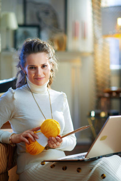 istock smiling elegant woman with yarn learn how to knit 1208978531