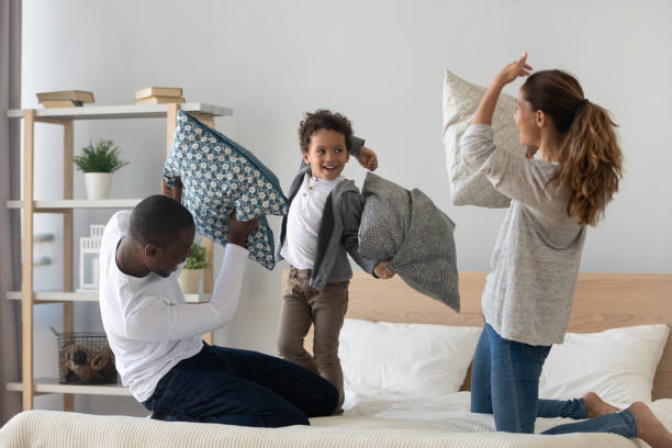 istock Excited small mixed race kid boy having fun with parents. 1208979484