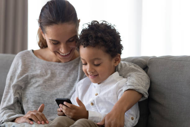 istock Happy young mother embracing son using educational applications on smartphone. 1208979504
