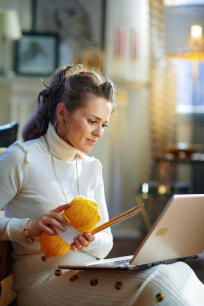 istock stylish woman with yarn learn how to knit 1208979532