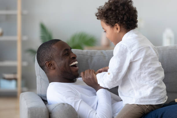 istock Overjoyed african american man playing with little cute son. 1208979563