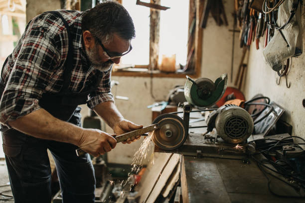 istock Senior man cutting metal in workshop 1208979620