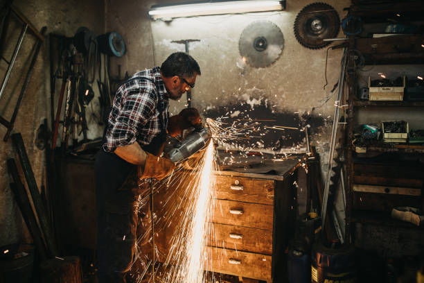 istock Senior man cutting metal in workshop 1208980754