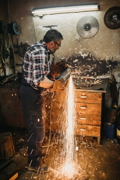 istock Senior man cutting metal in workshop 1208980773