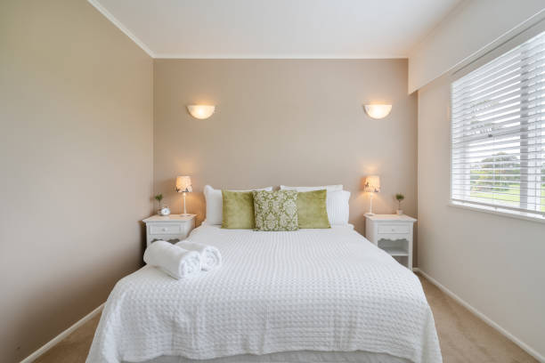 istock Bright double bedroom with gray walls. 1208982227