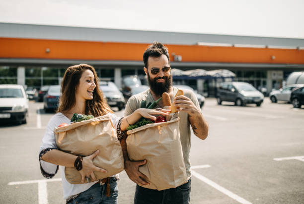 istock Young couple packing groceries 1208982970
