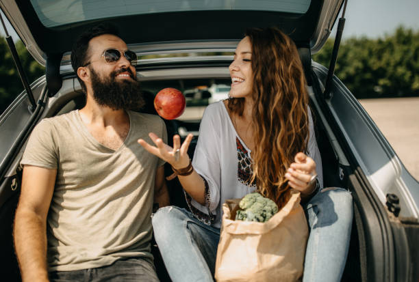 istock Young couple packing groceries 1208983064