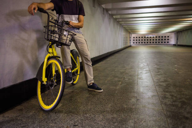istock Hipster sitting on a yellow modern bicycle 1208985091