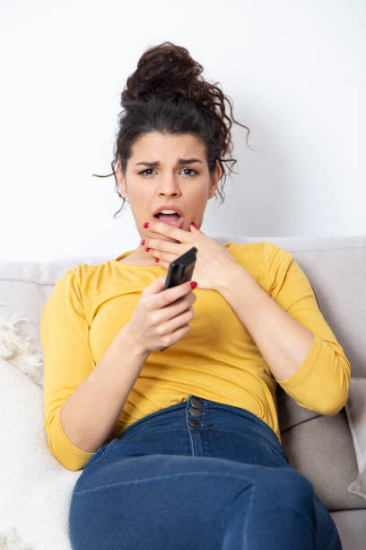 istock Scared woman watching terror movie 1208985247