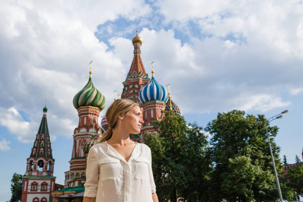 istock Curious young woman in front of Saint Basil's Cathedral 1208985254
