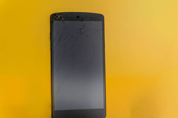 istock Smartphone with damaged screen on yellow background 1208986203