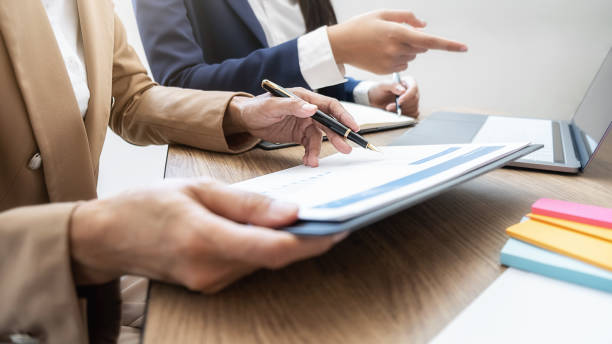 istock Business team brainstorming and discussing with financial data and report graph. Teamwork meeting working concept. 1208986831
