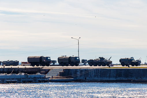 Large group of army vehicles in a military base.