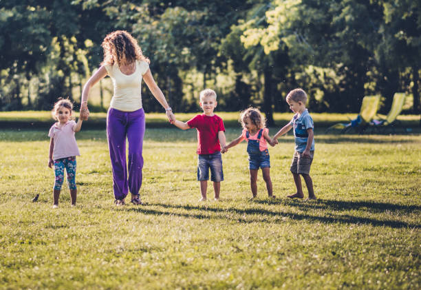 istock Group of happy children having fun while running in nature 1208989487