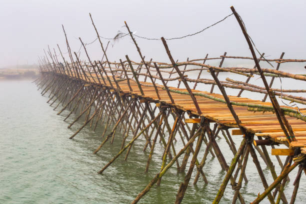 Traditional Vietnamese wooden bridge across Thu Bon river, at Hoi An. Vietnam
