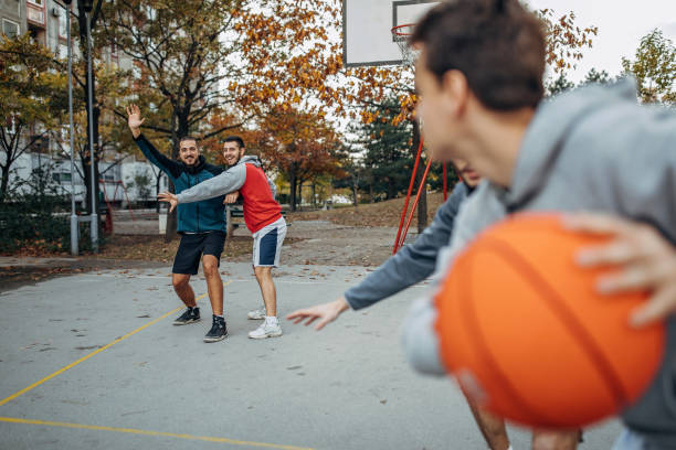 istock Friends play basketball 1208990178